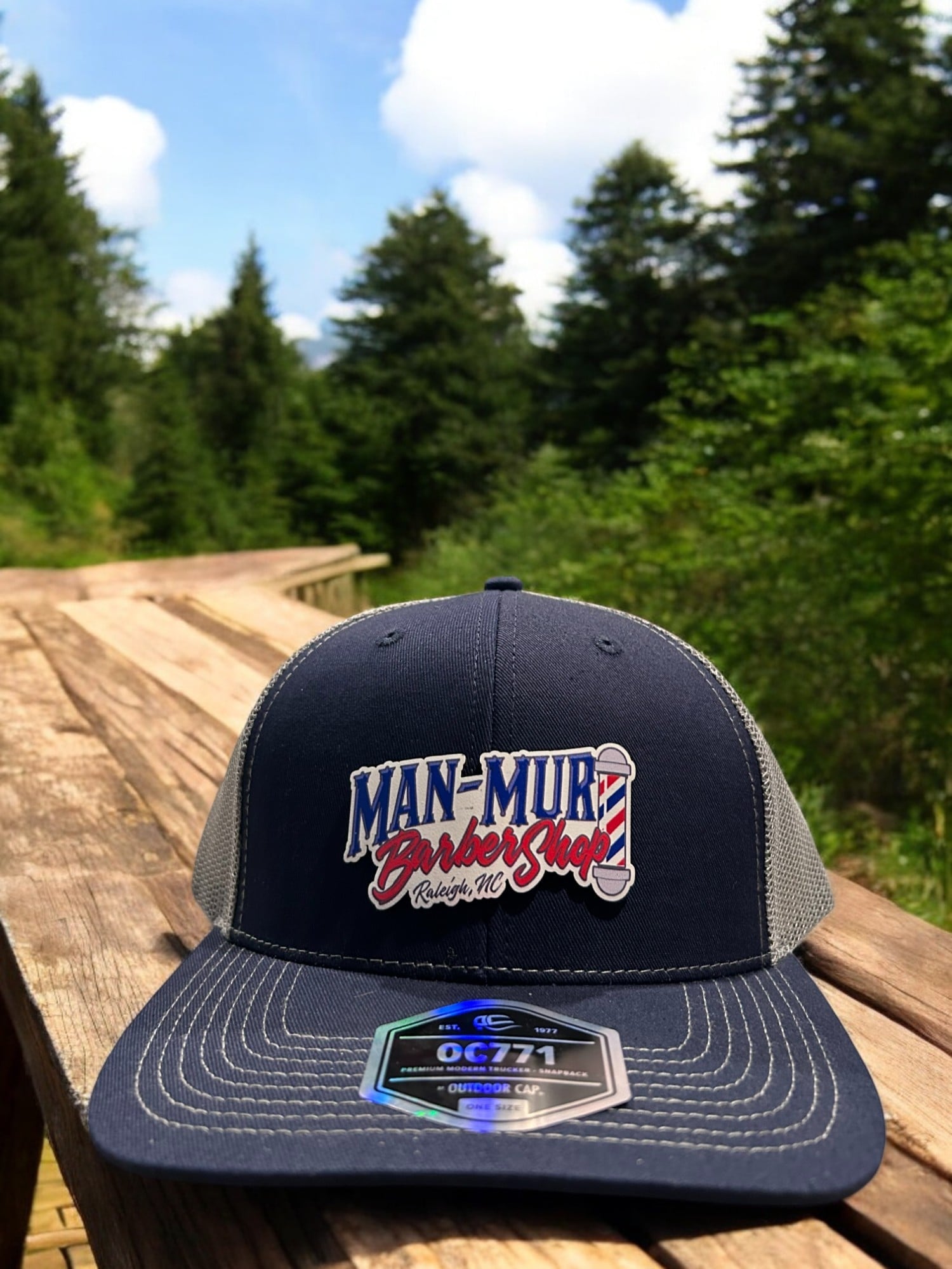 Man-Mur Barber Shop — Navy/grey trucker · full-color PVC patch logo