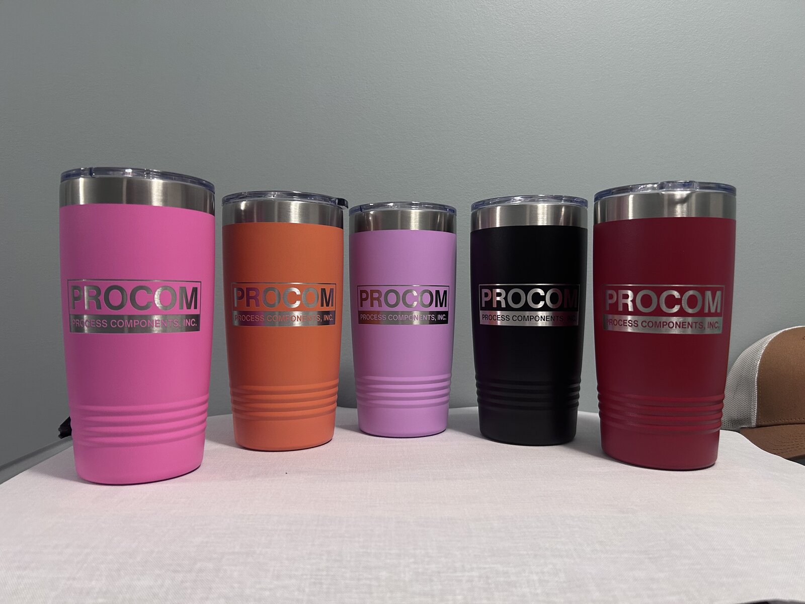 Procom — 20oz tumblers in five colors · engraved company logo